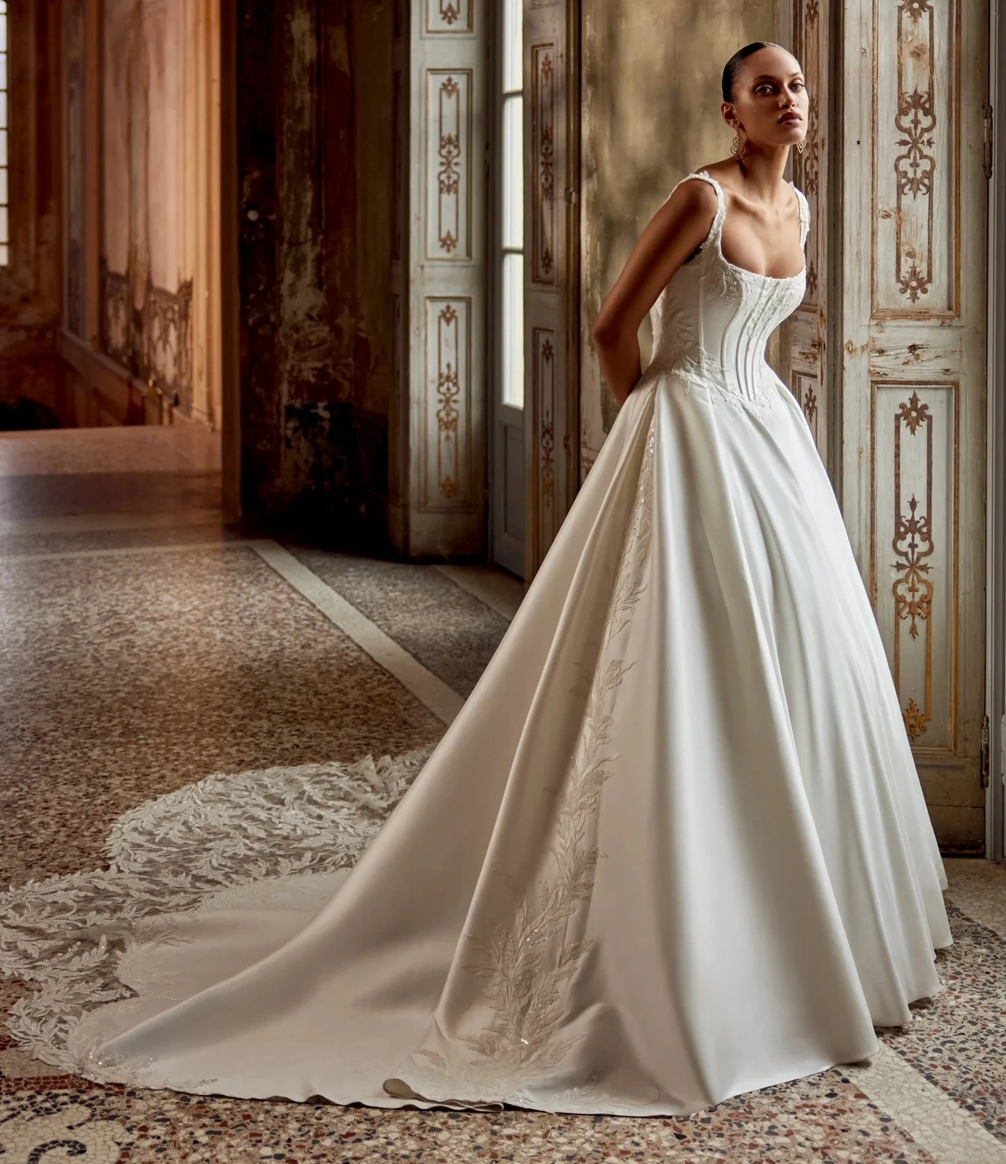 Model wearing white Justin Alexander dress