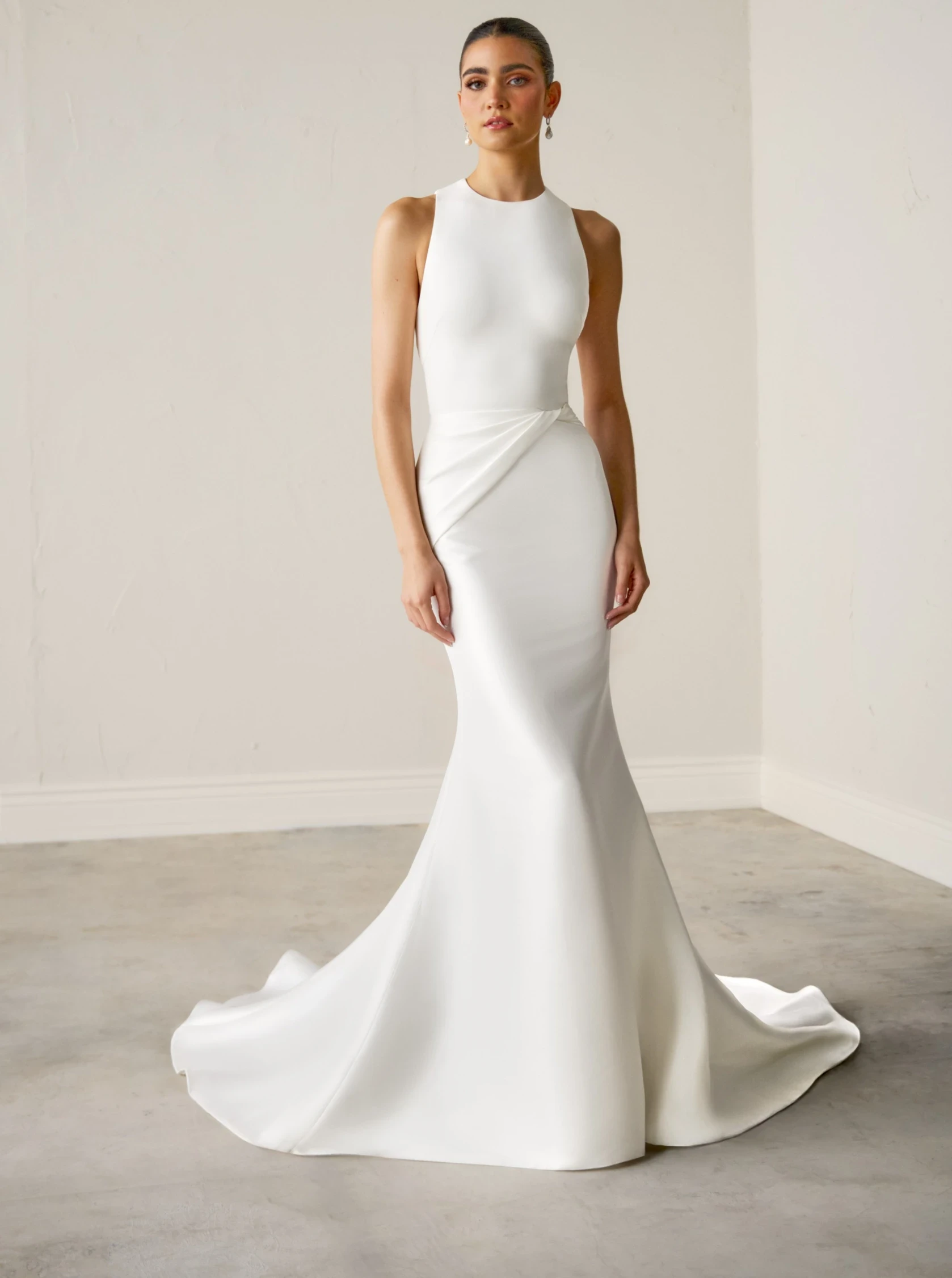 Model wearing white Justin Alexander Signature dress